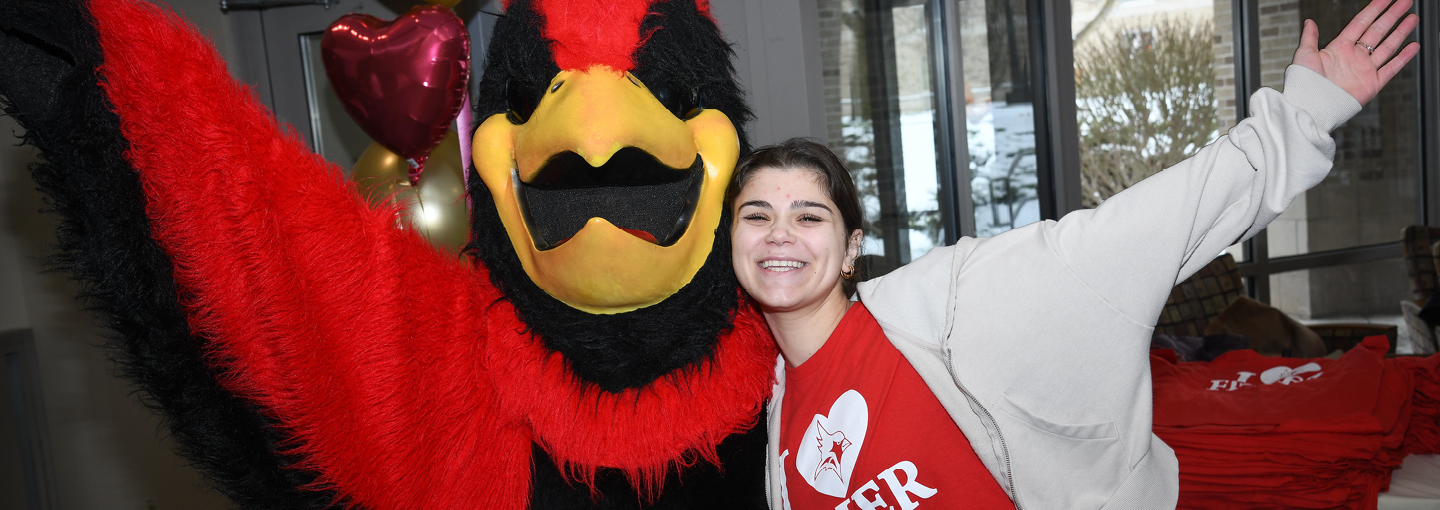 Cardinal and a student celebrate I Heart Fisher Giving Day