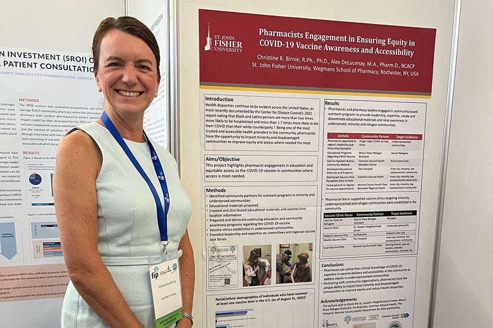 Dean Christine Birnie presents a poster at the FIP Conference.