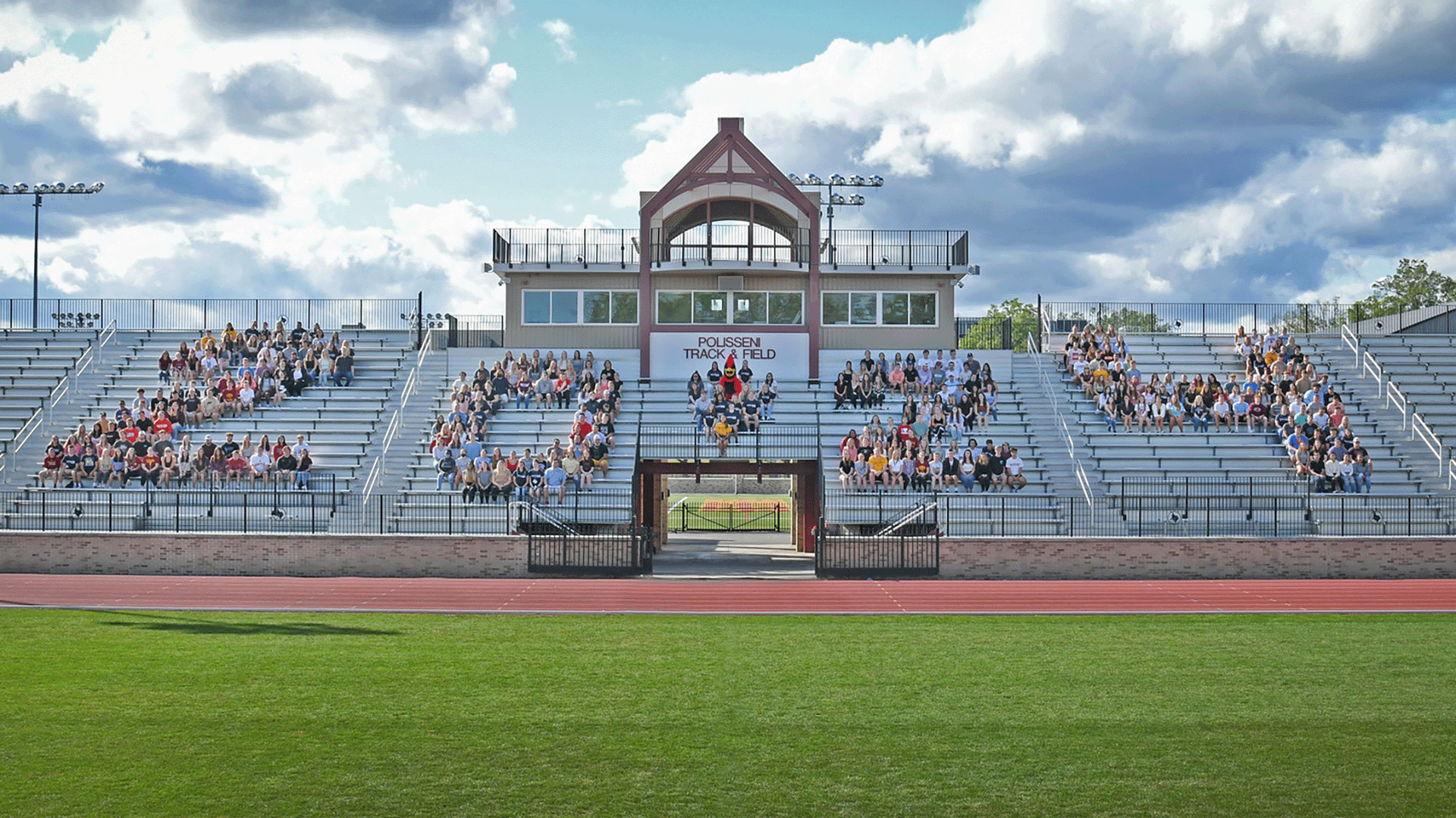 Students sit on bleachers in formation to create 2024.